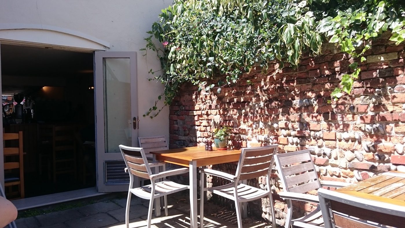 Tables in the walled brick courtyard