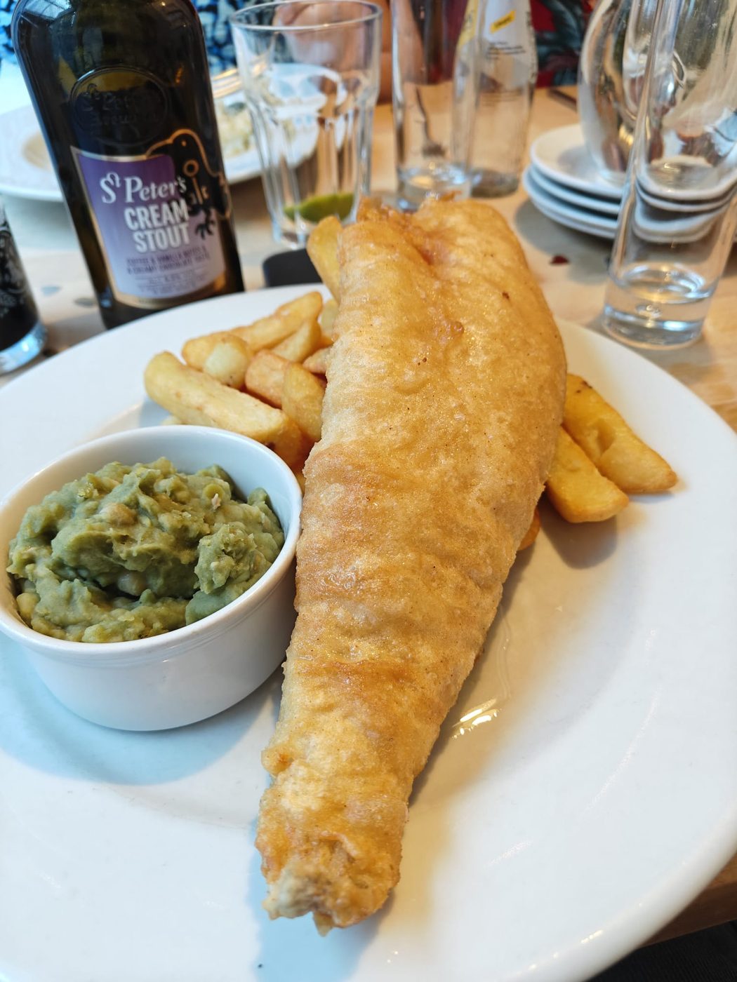 Battered fish and chips with mushy peas
