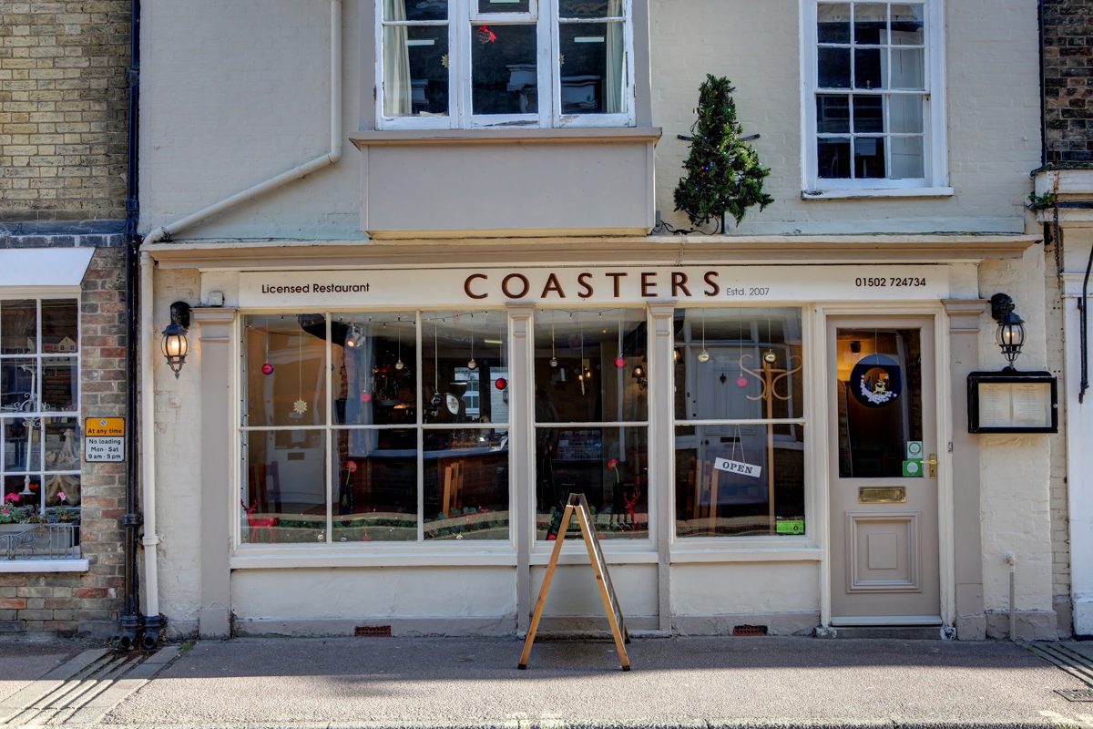 The cream shopfront with COASTERS lettering above the windows